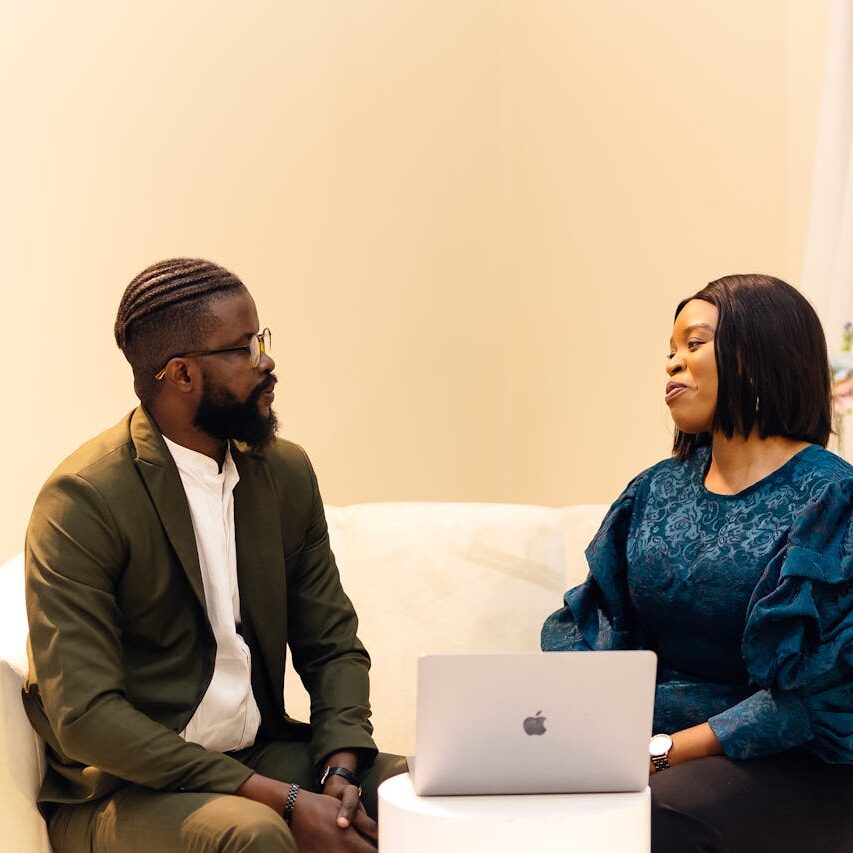 about-03 Two colleagues engaged in discussion in a Lagos office setting.